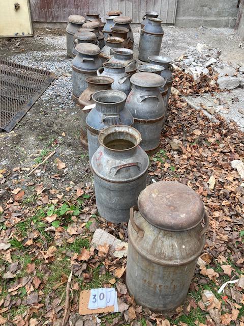 22 Antique Milk Cans: 22 antique milk cans. Some signed Crowley. Eight with lids, 14 without. 12" dia. x 25"h (with lids). From the Theresa, NY Estate. Please read the Terms and Conditions of this auction thoroughly for IM