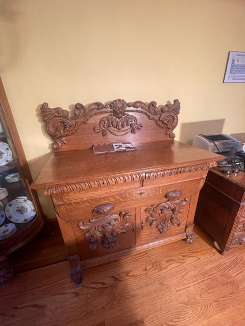 Golden Oak Clawfoot Sideboard with Carved Lion Heads: American golden oak clawfoot sideboard with backsplash and three hand carved lions heads. Professionally refinished. 48"w x 23.5"d x 53.5"h. From the Pompey, NY Estate. Please read the Terms and Condi