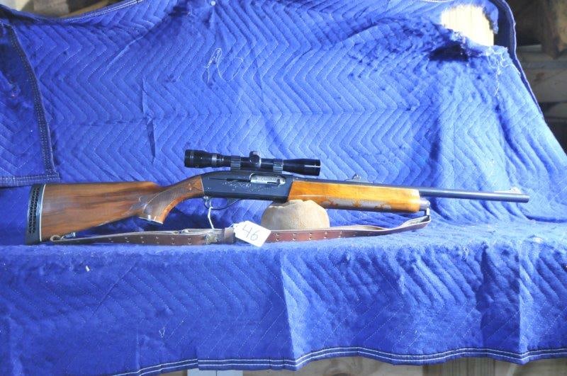 Remington 1100: Remington 1100. 12 gauge 2.75" slugs. 22" barrel. Rifle sights, smooth bore. Tasco 4x scope with rollover mount. Some pitting, few marks in the wood. Serial No. L9411516V.