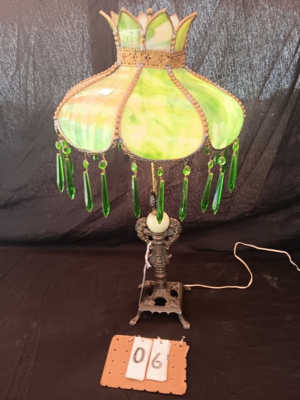 Estate Small Beautiful 1920s Green Slag Glass Panel Lamp: Consisting of green glass prisms, shade measuring 13"w x 8 1/2" high and base measurements 25" high. This lamp base has 2 winged angels on the column with green akro agate round insert with claw feet.