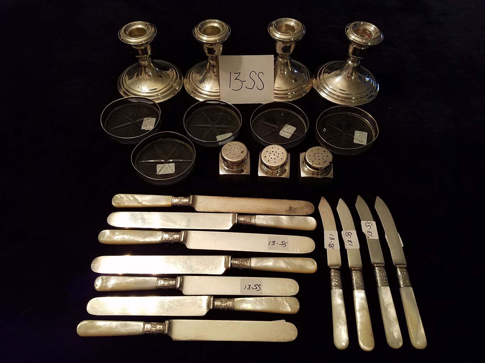 23 Pieces of Sterling & Misc. Pieces: 3- Sterling Gorham George Washington # 425 Salts B&M, 5 - Sterling & cut glass drink coasters, 4- Sterling weighted Gorham candlesticks #661, 11- Mother of pearl handled different sized knives (see ph