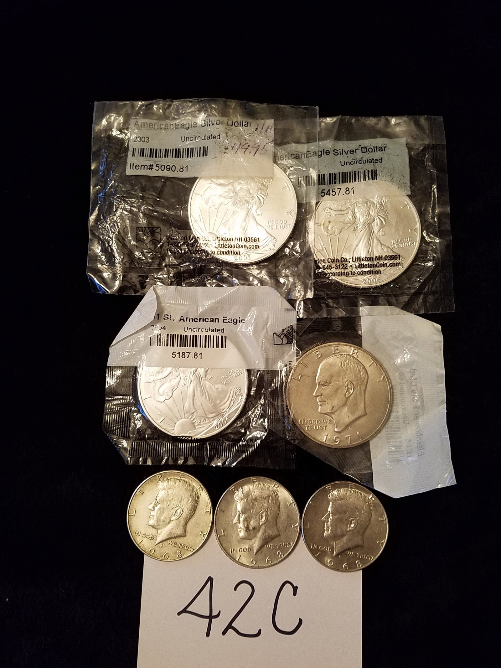 Seven US Silver Coins: Seven US silver coins. Three uncirculated American Eagle coins, one troy oz. of .999 silver, 2003, 2004 and 2006. Three 1968 Kennedy 40% silver half dollars. One 1971-S Eisenhower silver clad coin. Se