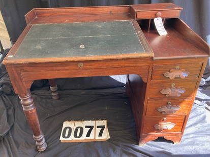 1860's Walnut Slant Front Lift Top Desk: 1860's walnut slant front lift top schoolmaster's desk with carved pulls. All drawers are hand dovetailed. There is a chip on the top back. Minor wear from use. 42"l x 26.50"w x 35.875"h. From the Liv