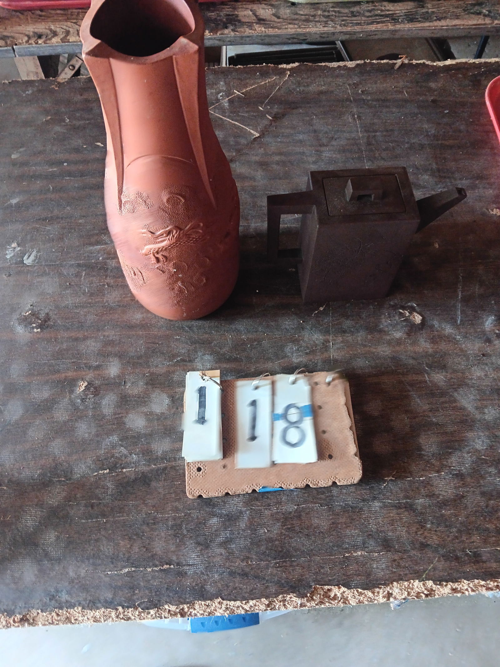 Two Vintage Japanese Pottery Pieces: Two vintage Japanese pottery pieces. One dragon redware unusual shaped vase, 5"w x 12"h. One pitcher with small chip on the lid and rosed incised into the sides, 7.75"l x 2.75"w x 6"h. Please read the