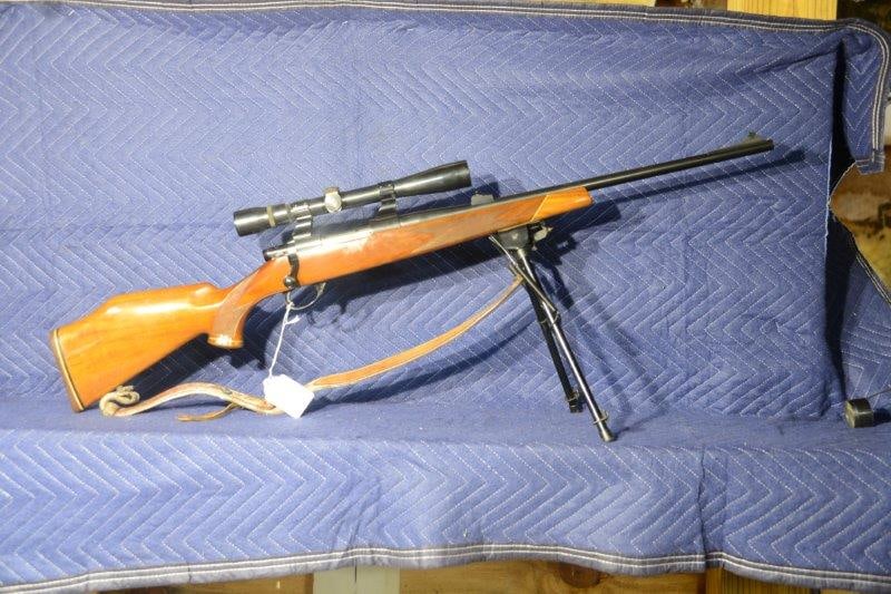 Weatherby Vanguard: Weatherby Vanguard 243 Winchester. Bolt action rifle with Weaver scope, Harris bipod and sling. 22" barrel with see through rings. Serial No. 00694.