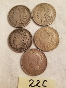 Four US Morgan Silver Dollars and One US Peace Dollar