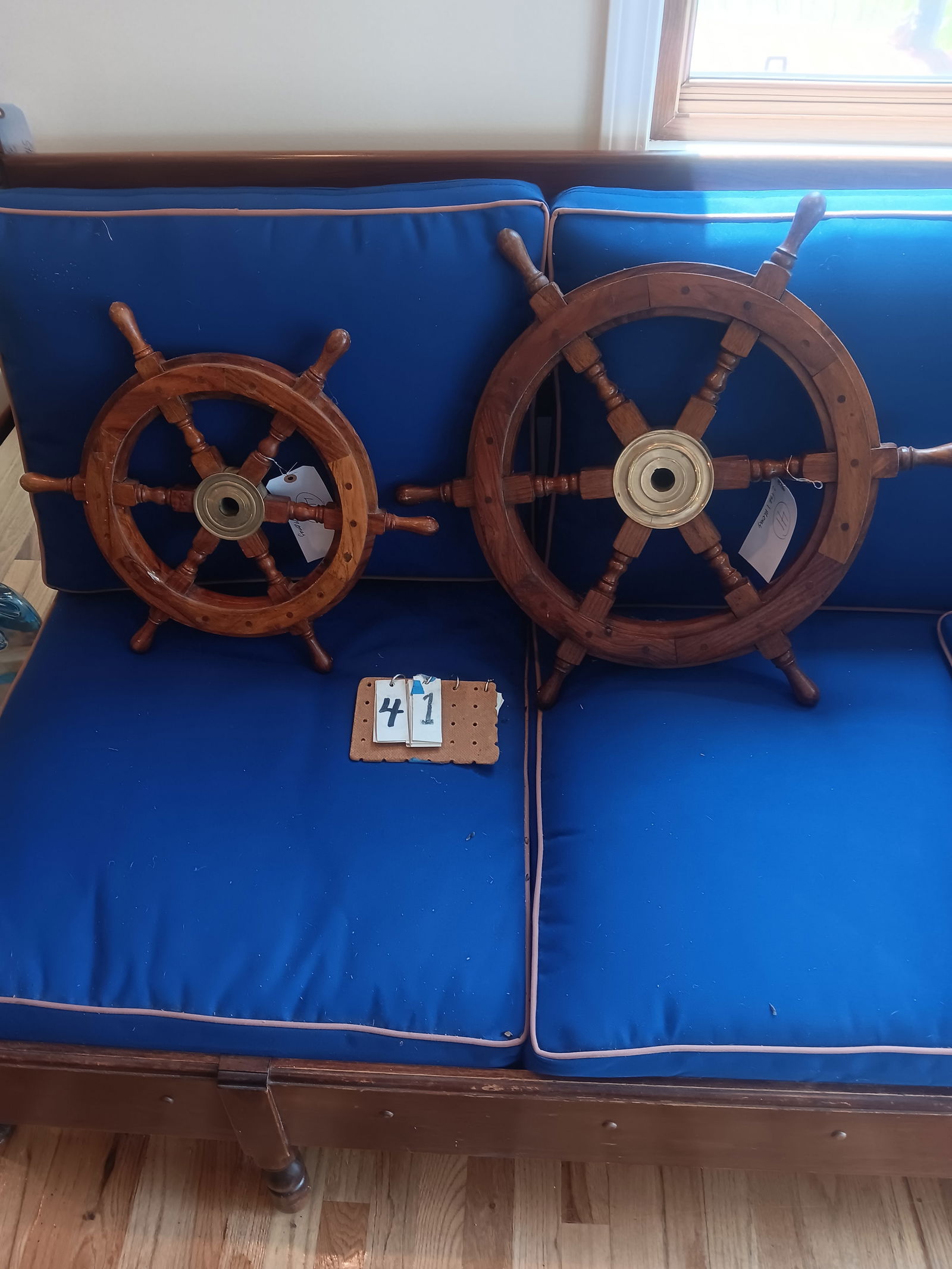 Two Contemporary Teak Ship Wheels with Inserts: Two nice contemporary teak wood ship wheels with brass and teak inserts. One 18.625" dia. x 2"d and one 24.5" dia. x 2"d. See photos. From the Dr. Thomas Fallon Collection.
