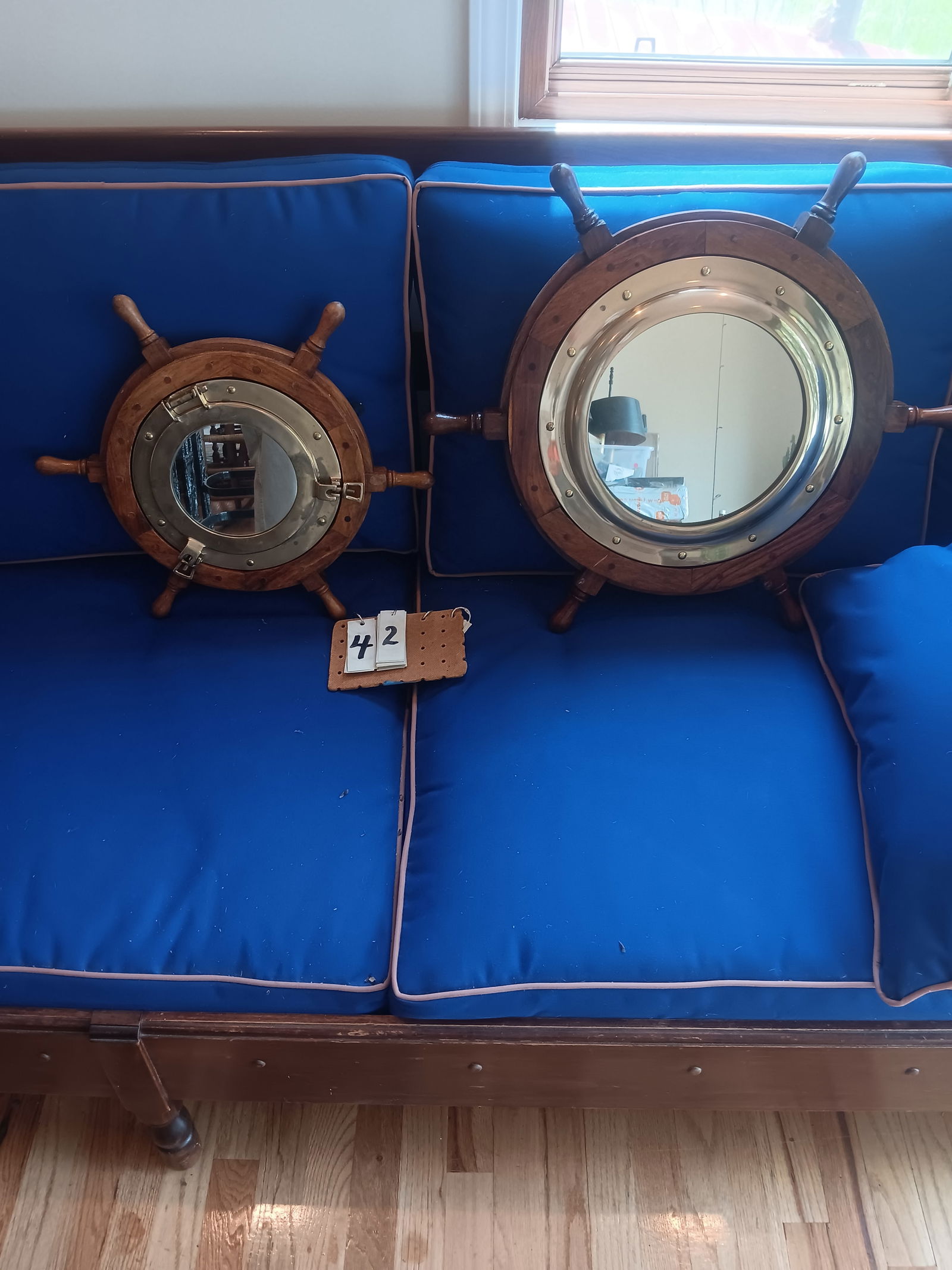 Two Contemporary Teak Ship Wheels with Mirrors: Two nice contemporary teak wood ship wheels with mirrors. One 18.125" dia. x 2"d and one 24" dia. x 2"d. See photos. From the Dr. Thomas Fallon Collection.