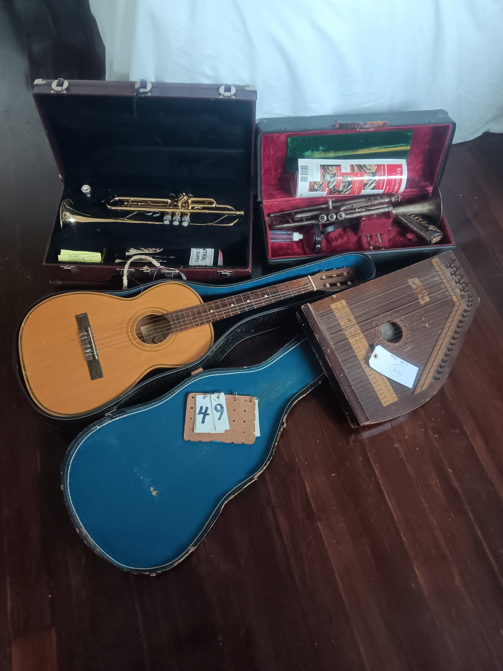 Four Musical Instruments: Four musical instruments. One Holton trumpet with dents and corrosion. One trumpet from Elkhart, IN. One Zither. One Giannini six-string guitar, made in Brazil. Guitar is Model 2, serial# 25167, made 