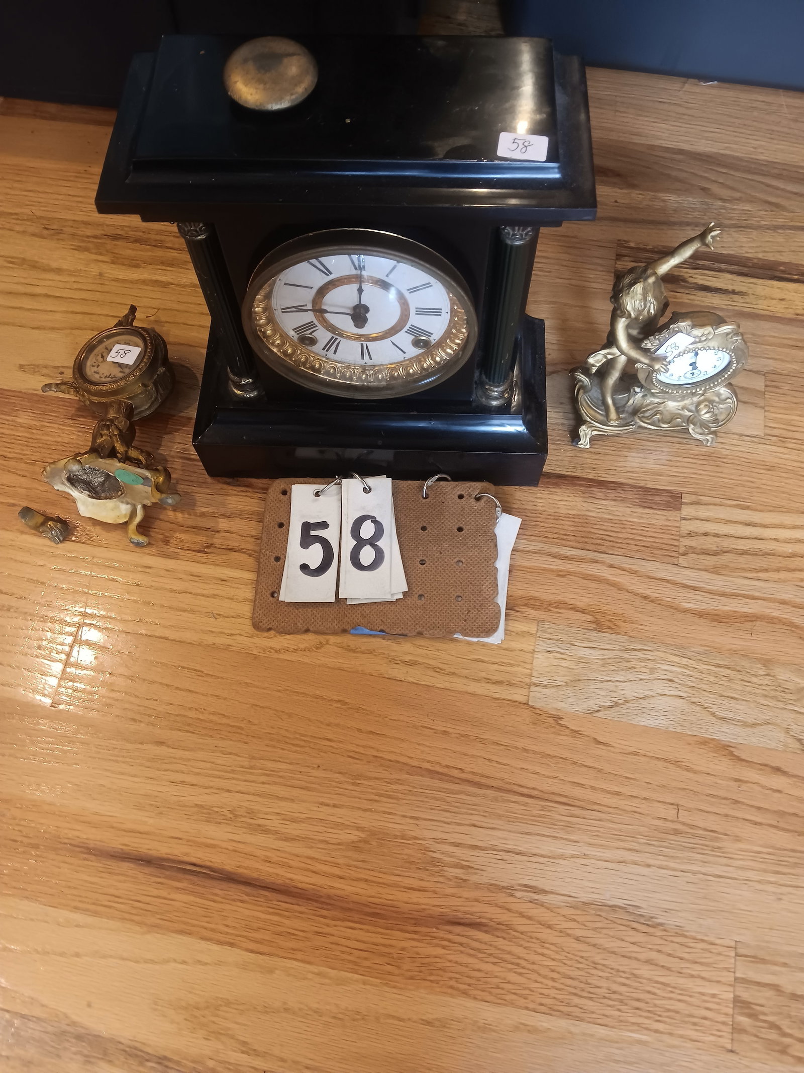 Three 19c Clocks: Three 19th century clocks. One Ansonia iron case clock in excellent condition. One boudoir clock with cherubs, Jennings, cracked. One boudoir clock with cherubs and deer, dated 1891. Foot broken but t