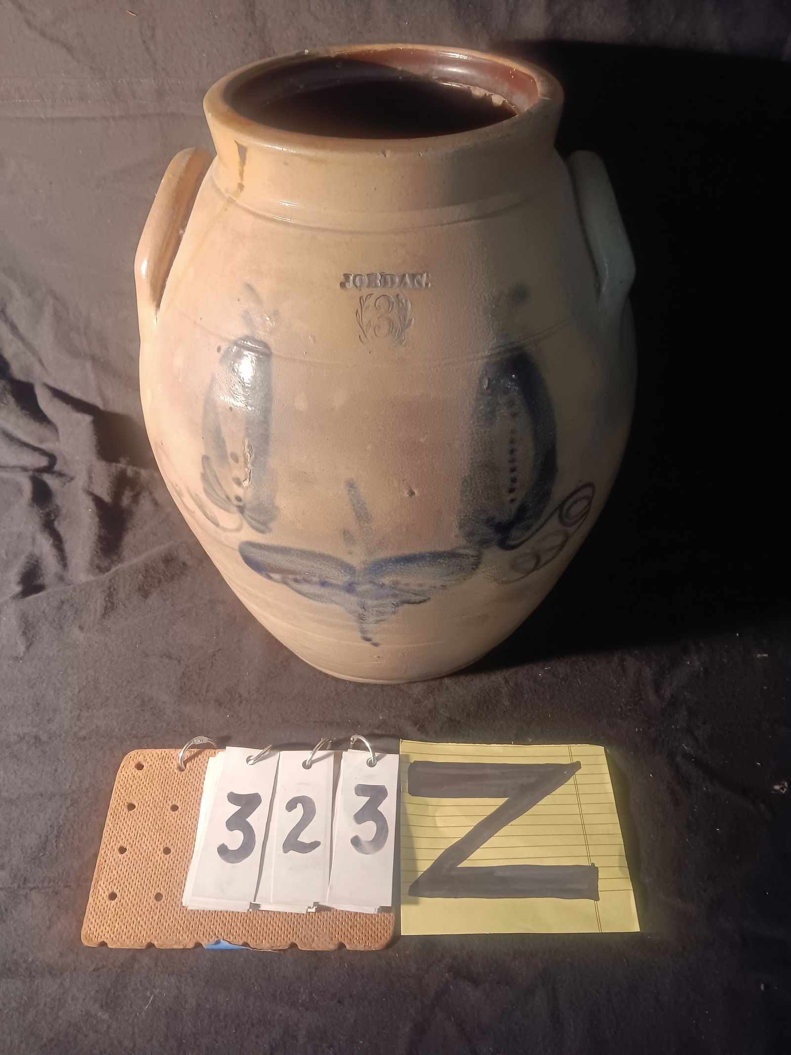 Rare 1830s Signed Jordan, NY Three Gallon Flower Crock: Rare 1830s signed Jordan, NY three gallon stoneware ovoid folky flower crock with impressed wreath around the #3. Some roughness and paint loss, small hole in back repair, cracked in the back. 11" dia