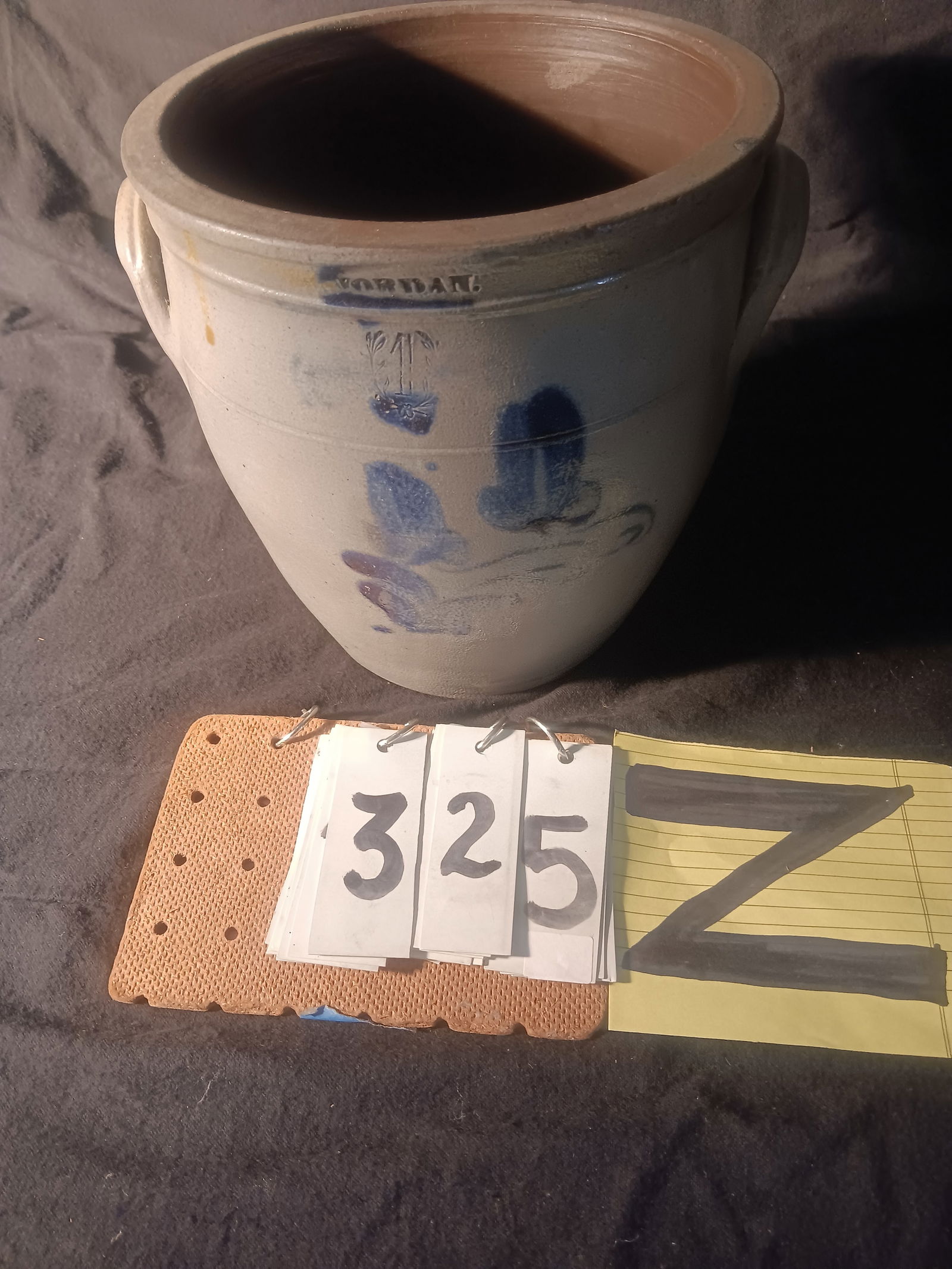 Rare 1830s Jordan, NY One Gallon Stoneware Crock: Rare 1830s Jordan, NY one gallon ovoid stoneware crock with impressed wreath and two flowers. Has hairline crack in the center of Jordan and small chip on the top back. 8.5" dia. x 8.25"H. See photos.