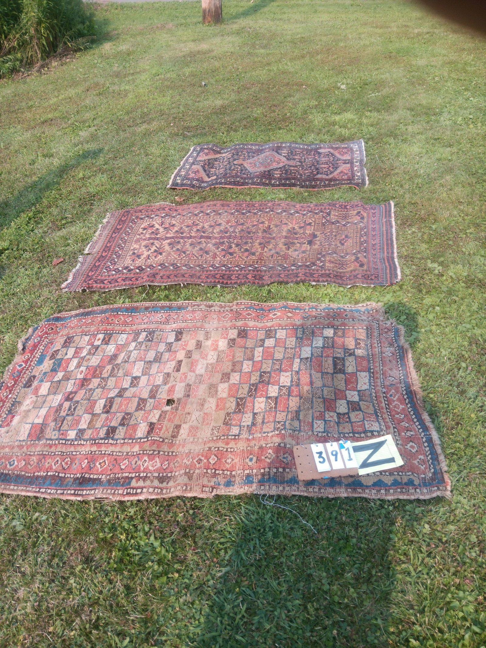 Three Handmade Antique Persian Oriental Rugs: Three handmade antique Persian Oriental rugs. 34.75"w x 59.625"l, 33"w x 60"l x 30.25"w x 48.25"l. See photos. From the Fairmont, NY estate of Carrie Gannett, and advanced antique, art and jewelry col