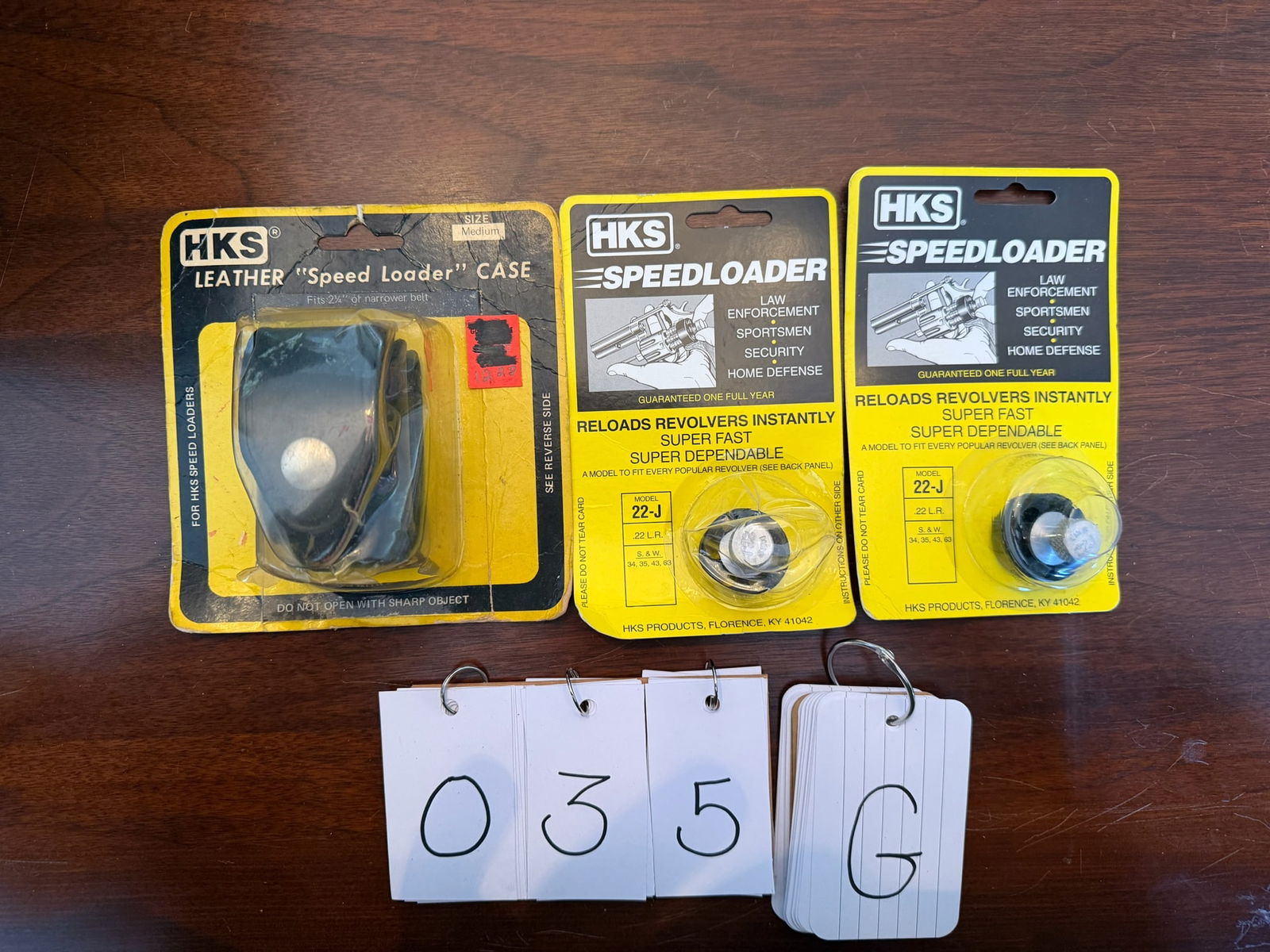 Two Smith & Wesson 22LR Speed Loaders: Two Smith & Wesson 22LR speed loaders. Manufactured by HKS. Fit Smith & Wesson Model 34/35/43/63. Model No. 22-J. New in the packaging. Also includes one leather HKS speed loader belt pouch (new).