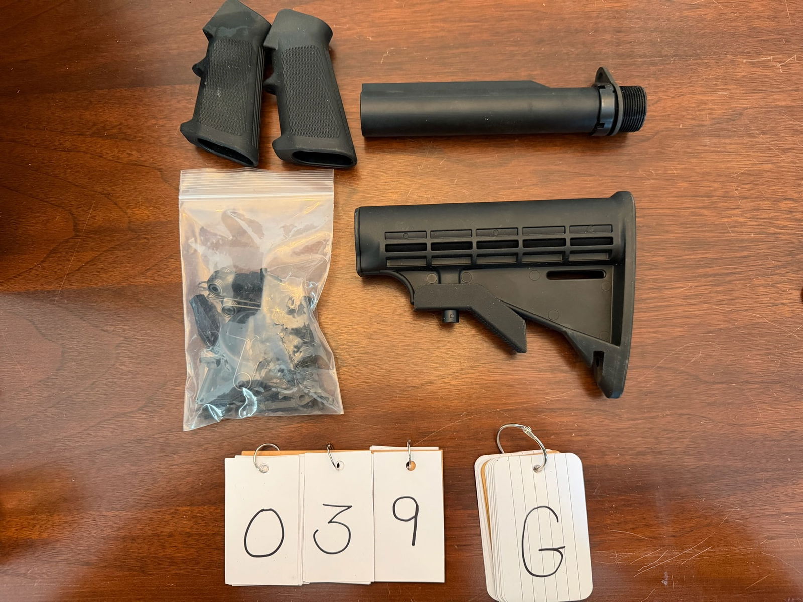 Assorted Lot of New AR-15 Pieces and Parts: Assorted lot of new AR-15 pieces and parts. Includes six position buffer tube stock, two A2 grips, plastic lower parts kit (complete). See photos.
