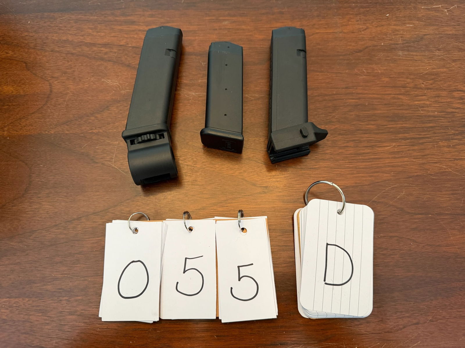 Three Assorted Glock Magazines: Three assorted Glock magazines. One 40 caliber, 15 round with flashlight holder. One 9mm, 17 round with rail adapter base plate. One 9mm, 15 round. See photos. LEO, FFL OR OUT OF STATE SALES ONLY. MAG
