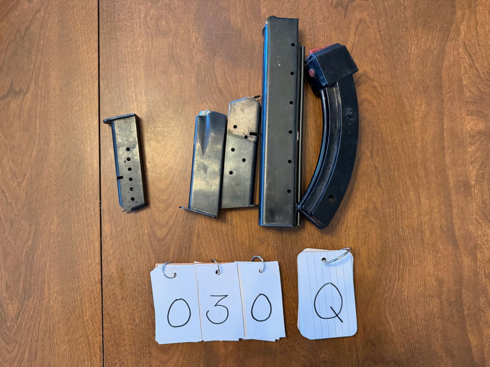 Assortment of Holsters and Magazines: Assortment of holsters and magazines. One Butler Creek Corp. 30 Round Ruger 10/22 magazine. One new US 30 round 45 caliber magazine. Three additional unknown smaller magazines. One Safariland leather