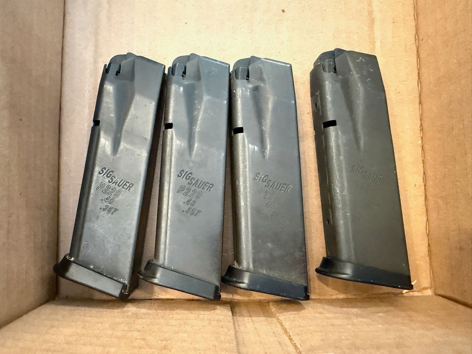 Four Sig Sauer P229 12 Round Magazines: Four Sig Sauer P229 12 round magazines. 357 Sig or 40 caliber. See photos.