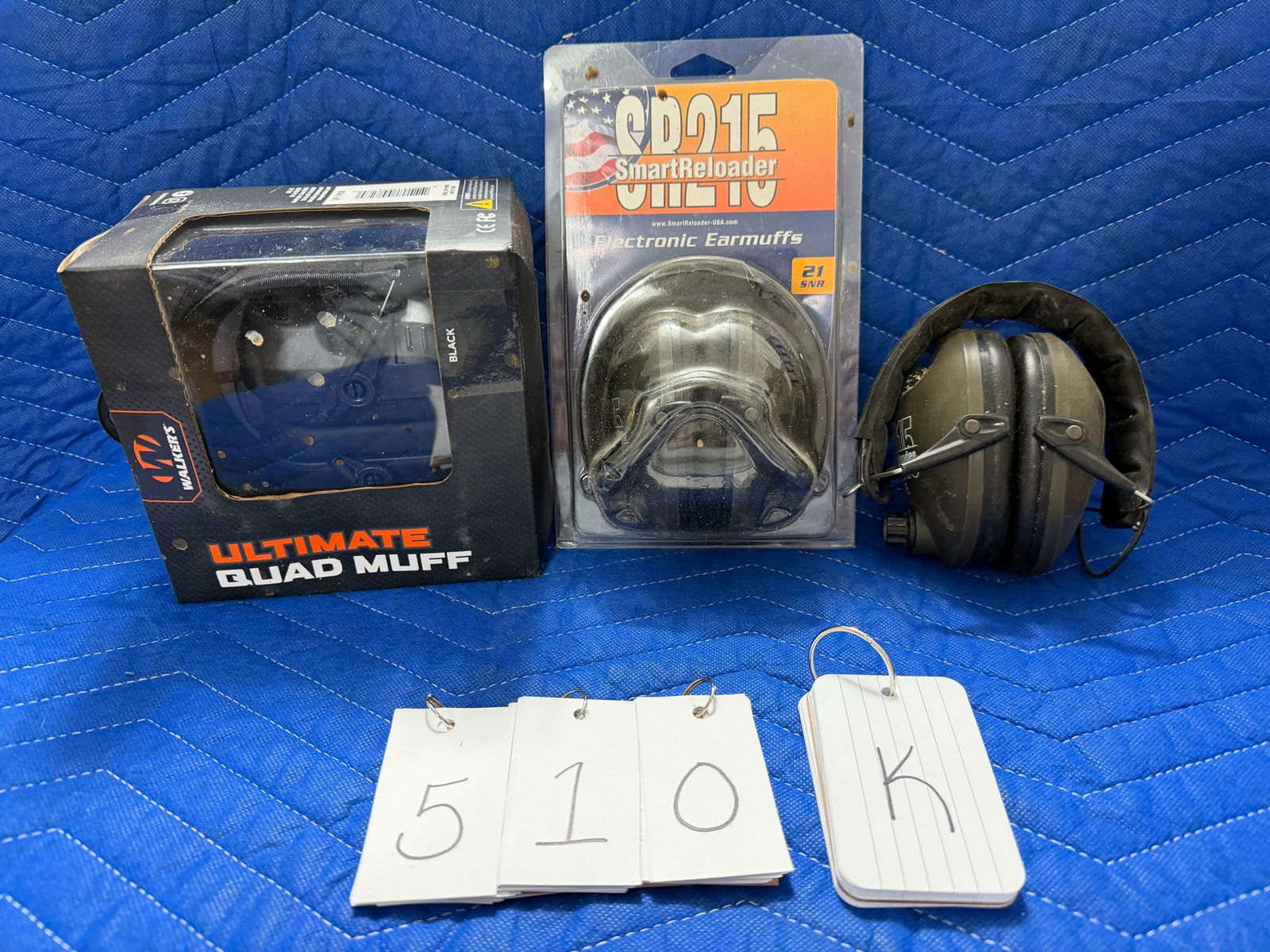 Assorted Lot of Hearing Protection: Assorted lot of hearing protection. One Walker's Ultimate Quad Muff, new in the package. Two SR215 Smart Reloader Electronic Earmuffs - one new in the package and one out of the package. See photos.