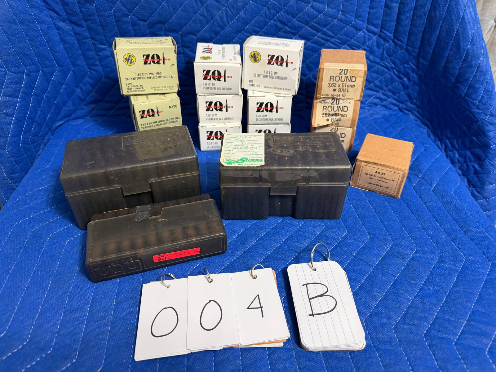 7.62x51mm NATO Ammo: 7.62x51mm NATO ammunition. Three green boxes of 20 rounds each loaded into four stripper clips (five rounds per clip), 60 rounds. Six white boxes of MKE ZQ, 147 grain FMJ (120 rounds). Three green