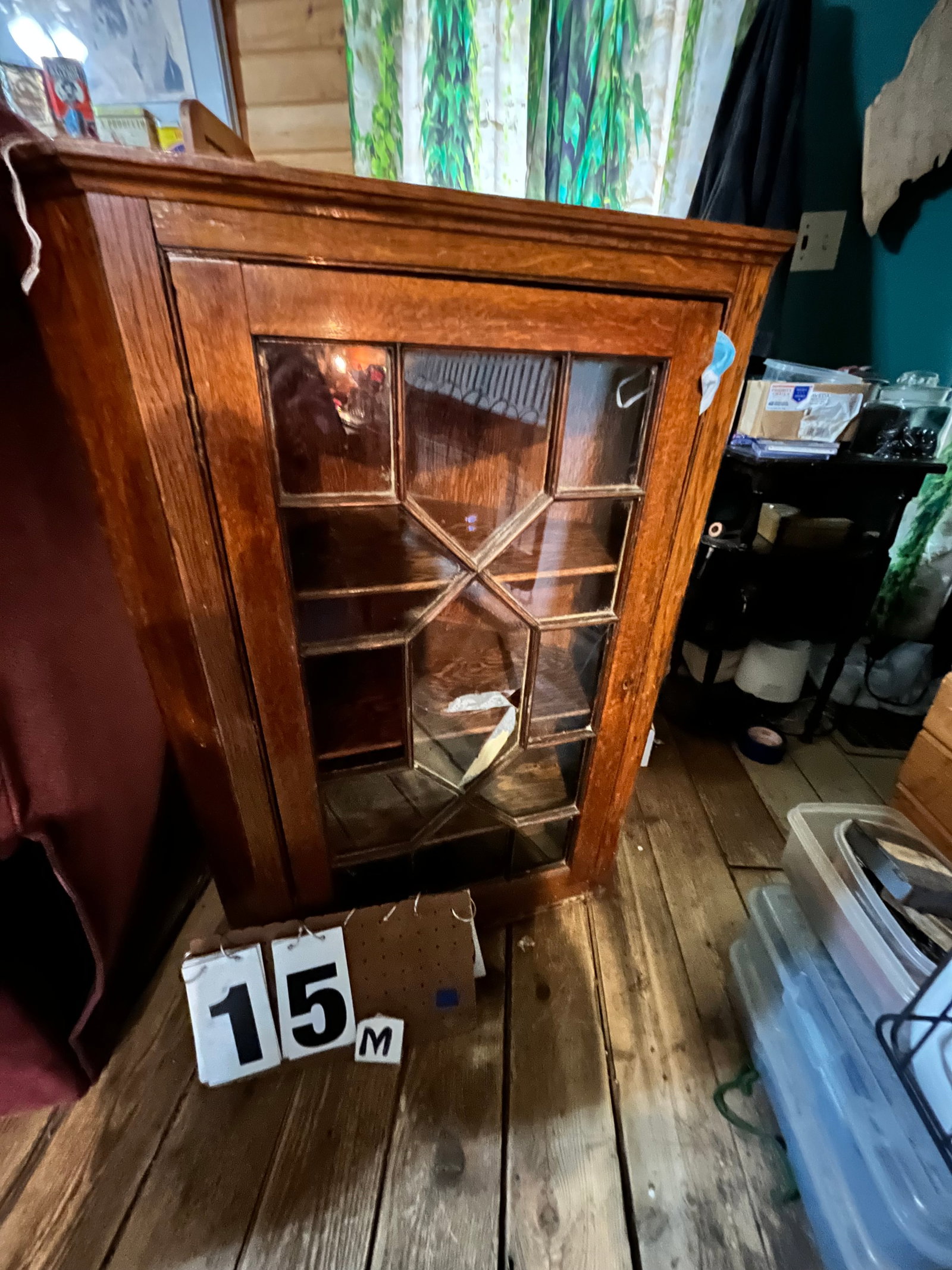 1900s Oak Hanging Corner Cabinet: 1900s oak hanging corner cabinet with glass door. Missing one glass piece. 27"w x 16"d x 38"h. See photos. Please read the Terms and Conditions of this auction THOROUGHLY for IMPORTANT bidder