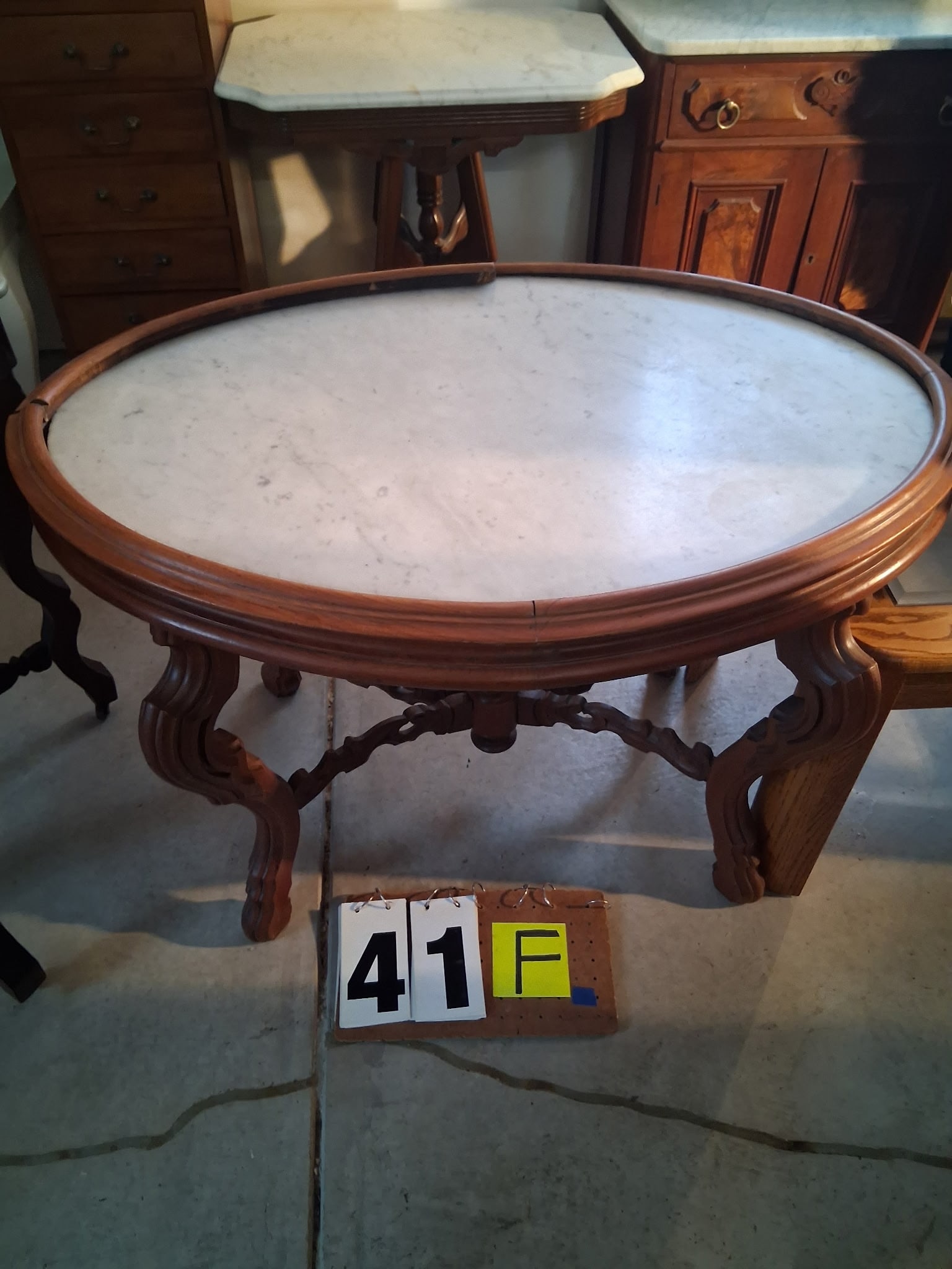 Oval Marble Top Table: Oval marble top table. 39.75"l x 27.25"w x 27.25"h. See photos. Please read the Terms and Conditions of this auction THOROUGHLY for IMPORTANT bidder information.
