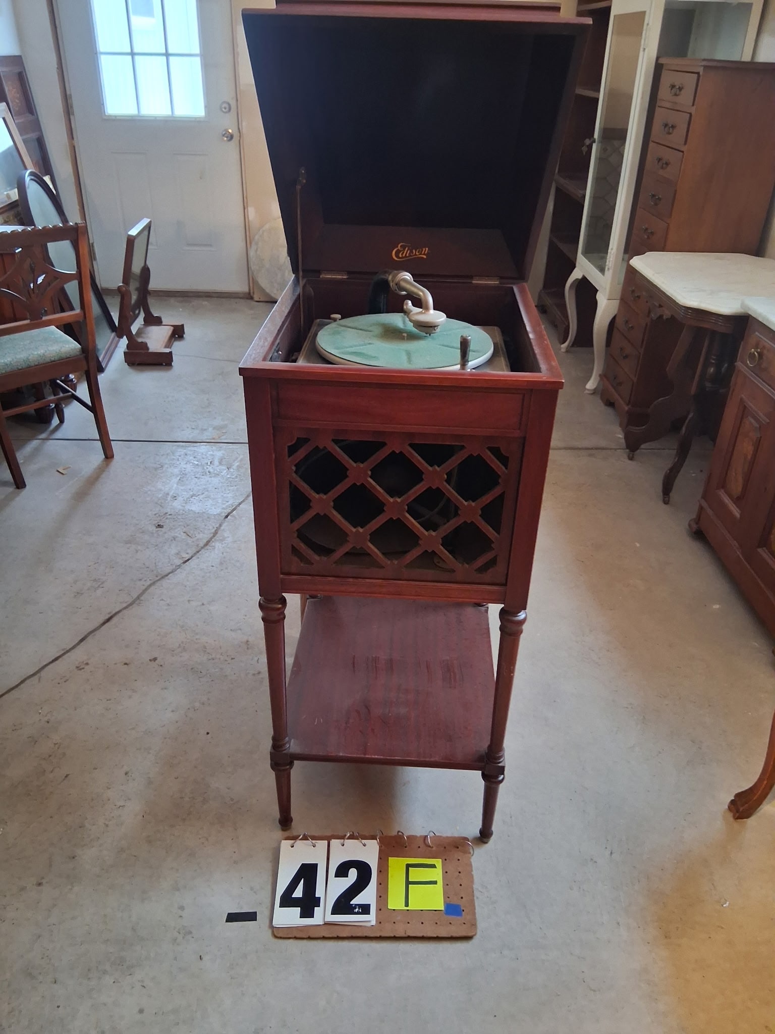 Mahogany Edison Crank Diamond Disk Wind Up Victrola: Mahogany Edison Crank Diamond Disk Wind Up Victrola. In working condition. Model A-100. Comes with records. 18.5"w x 21.25"d x 41.75"h. See photos. Please read the Terms and Conditions of this auction