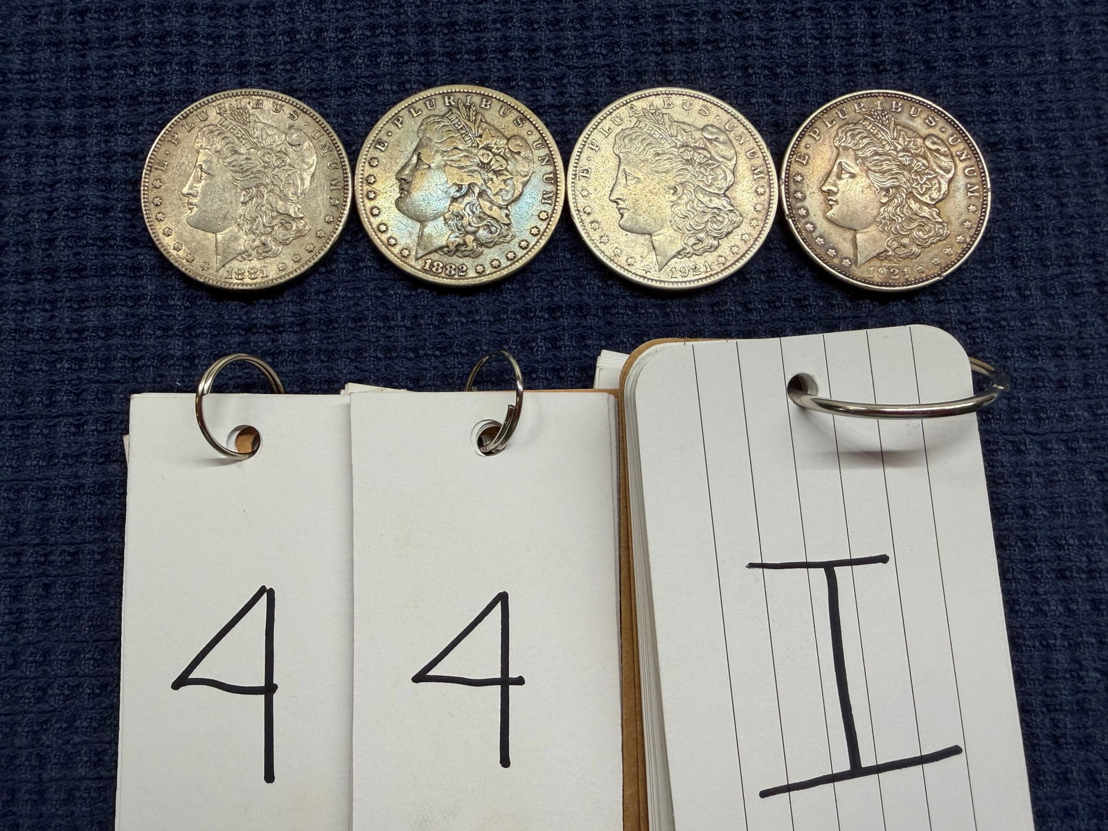 Four US Morgan Silver Dollars: Four US Morgan Silver Dollars. One 1881, one 1882, one 1921 and one 1921. See photos. Please read the Terms and Conditions of this auction THOROUGHLY for IMPORTANT bidder information.