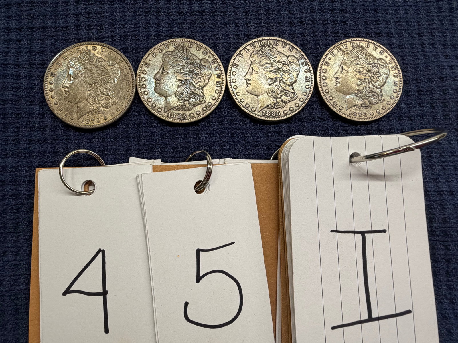 Four US Morgan Silver Dollars: Four US Morgan Silver Dollars. One 1879, one 1880-O, one 1883 and one 1885. See photos. Please read the Terms and Conditions of this auction THOROUGHLY for IMPORTANT bidder information.