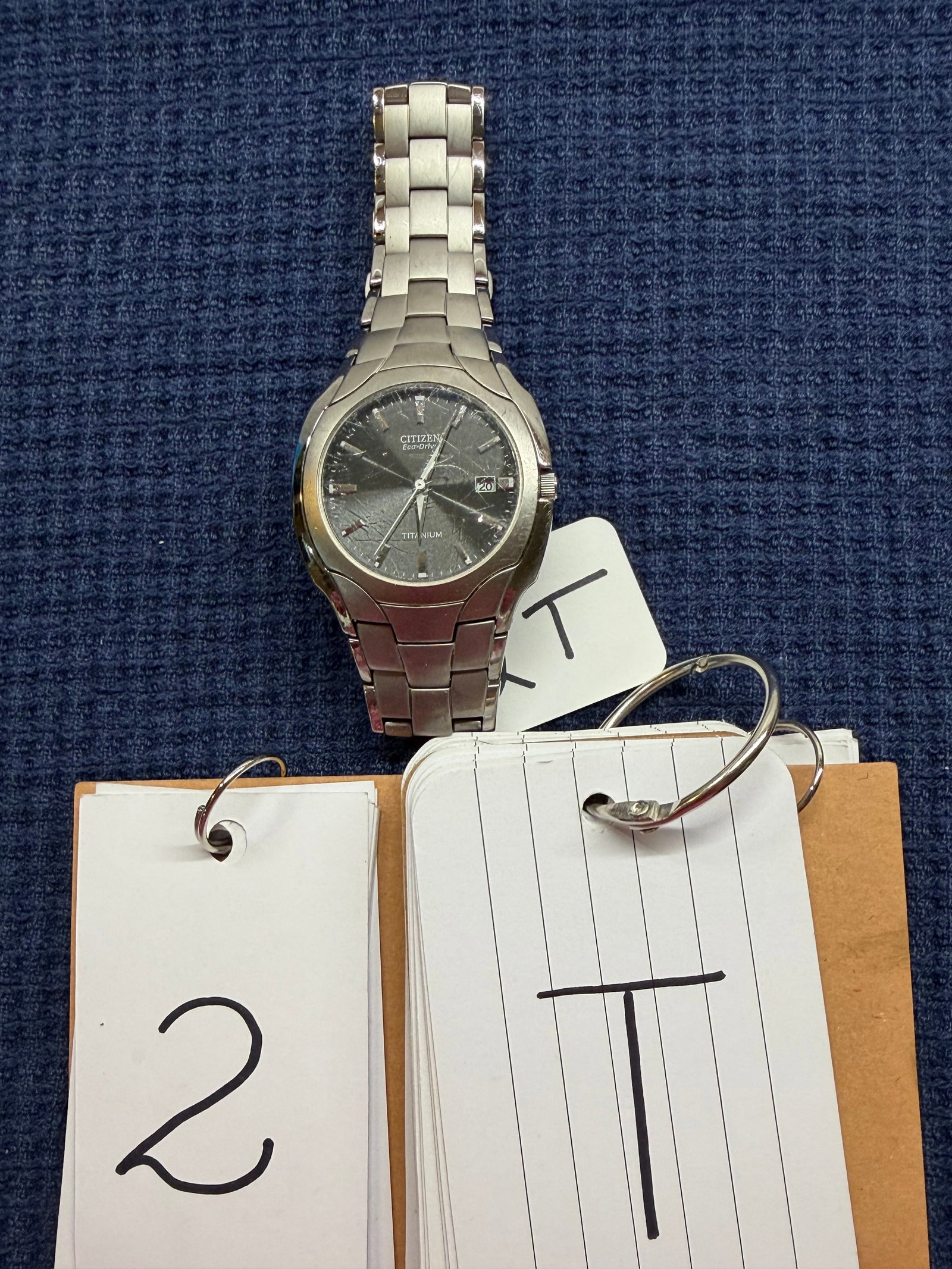 Citizen EcoDrive Titanium Date Watch: Citizen Eco-Drive titanium date watch. Silver in color. Cleaned and verified to be in working condition by professional jeweler. Crystal has scratches. See photos. Please read the Terms and Conditions