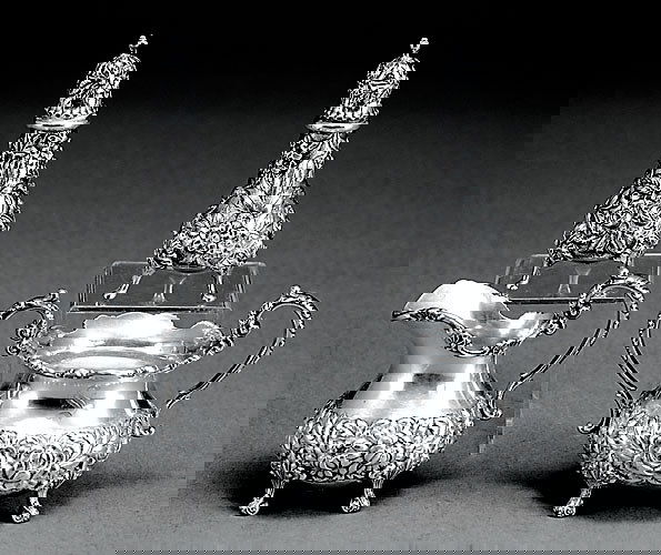 American sterling table accessories: Desc: Steiff cream and sugar set, H4"; S. Kirk & Son salt and pepper shaker, H5"; all heavily repousse-chased with floral design and marked. (Good condition) Size: 20.0oz