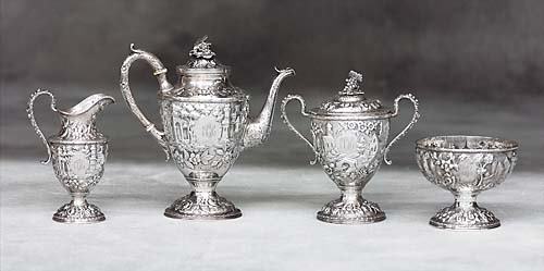 S. Kirk & Son four-piece sterling coffee service c: S. Kirk & Son four-piece sterling coffee service circa 1861-1903 each in architectural and floral repousse design, comprising: one coffee pot, H11"; covered sugar, H9"; creamer, H7 1/2"; waste bowl,