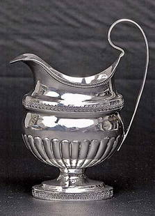 American coin silver creamer circa 1850: American coin silver creamer circa 1850 shaped spout and rim with decorative border above foliate band and reeded body on oval pedestal base, unmarked. (Good condition, wear consistent with