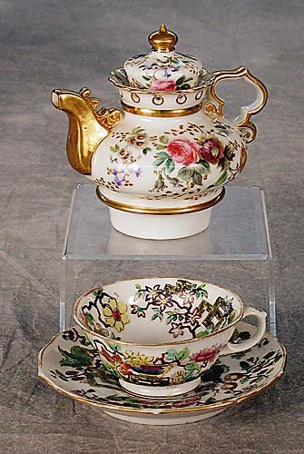 Three pieces of Paris porcelain Jacob Pe: Three pieces of Paris porcelain Jacob Petit teapot and cup and saucer 19th century teapot has a dome-shaped lid on a squat body; decorated with floral sprays, marked JP with dots, blue underglaze; cup