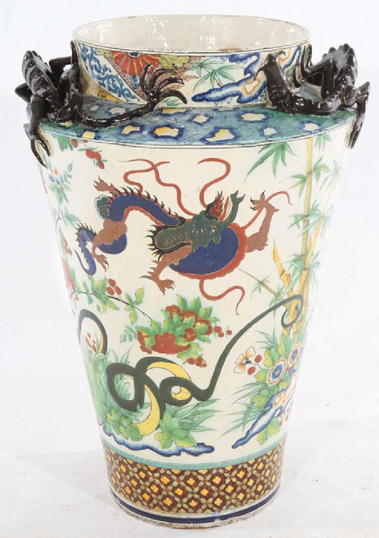 GLAZED EARTHENWARE FLOOR VESSEL CIRCA 1900: A very interesting, possibly French, multicoloreed glazed earthenware floor vessel in the Japanese taste circa 1900. Having dragon handles and floral, bird and butterfly decoration. Dia: 17.5"