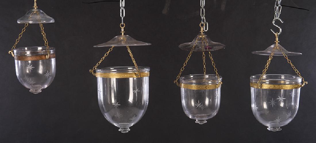FOUR GLASS ETCHED STAR DESIGN HANGING LANTERNS: A good lot of four glass etched star design British Colonial style hanging lanterns. Ht: 18" Dia: 9" (largest)