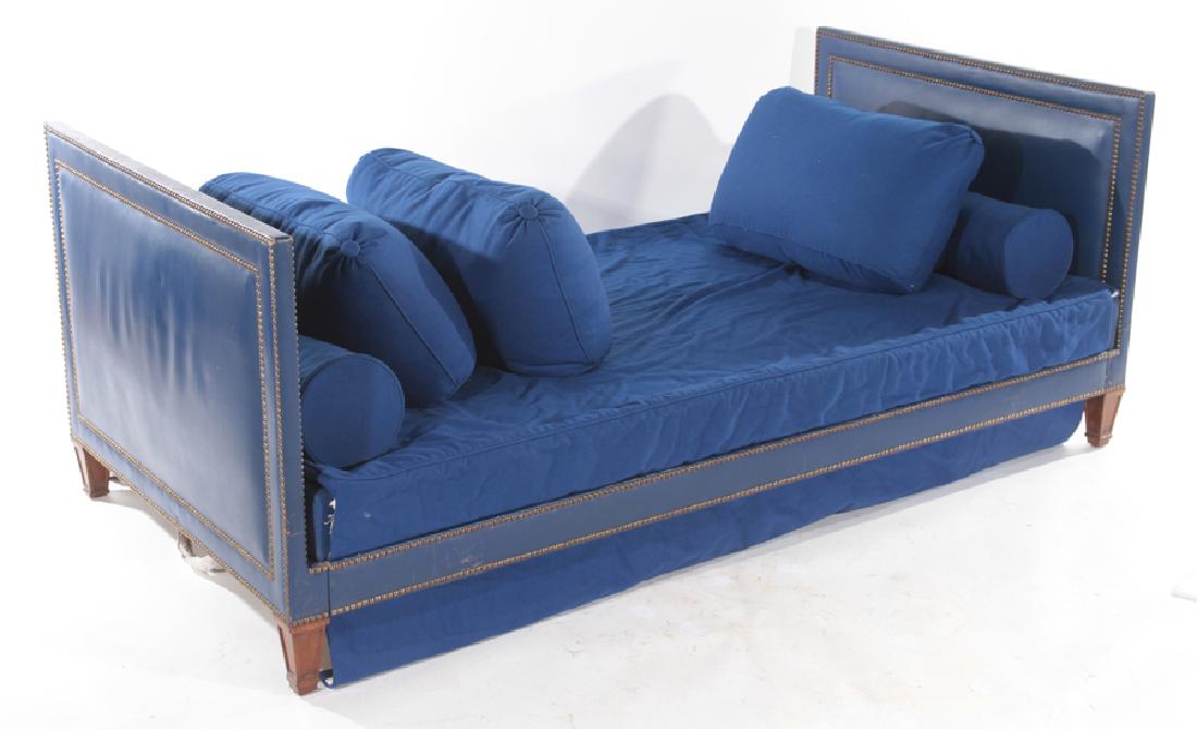 JEAN MICHEL FRANK MAHOGANY BLUE LEATHER DAY BED: A mahogany and blue leather day bed having brass studded decoration and loose cushions in the manner of Jean-Michel Frank. Raised on tapered wood legs. Ht: 30" Wd: 75.5" Dpth: 39"