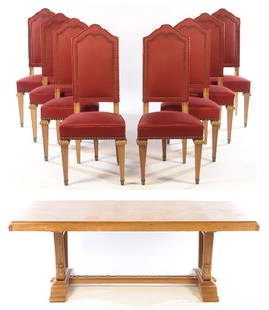 8 FRENCH OAK DINING CHAIRS AND TABLE C.1950: A set of eight French oak dining chairs and table attributed to Jean-Charles Moreux circa 1950. The chairs having a tomb stone back with nail head trim. The table having a parquet top with a two pull