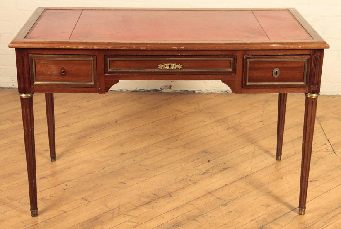 LOUIS XVI STYLE MAHOGANY BUREAU PLAT C.1930: A Louis XVI style mahogany three drawer bureau plat having embossed leather top and bronze trim circa 1930. Ht: 30" Wd: 47" Dpth: 26"
