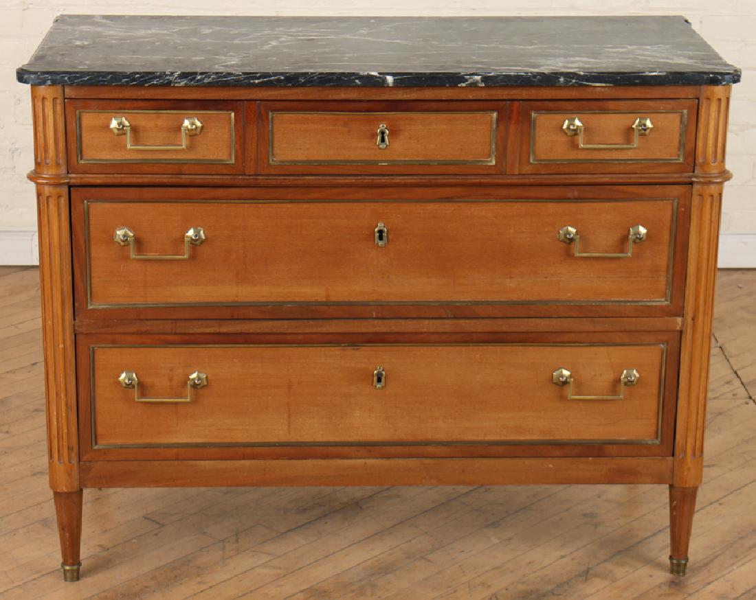FRENCH LOUIS XVI STYLE MARBLE TOP COMMODE: A French Louis XVI style mahogany marble top commode circa 1940. Having three drawers with brass banding fluted column corners and fluted tapered legs. Ht: 34" Wd: 42.5" Dpth: 18.5"