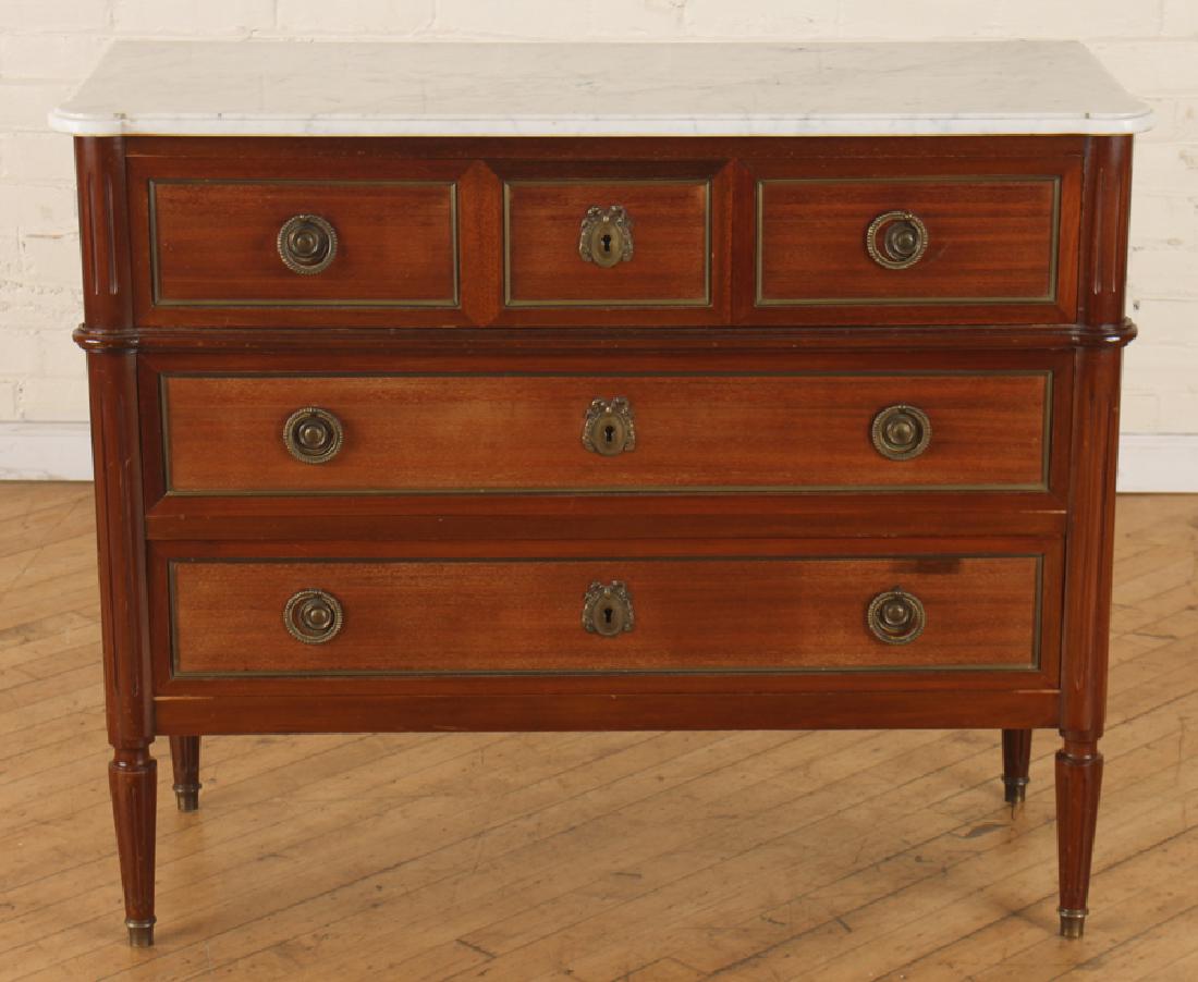 LOUIS XVI STYLE MAHOGANY MARBLE TOP COMMODE: A French Louis XVI style mahogany marble top commode comprised of three drawers raised on fluted and tapered legs circa 1950. Ht: 32.5" Wd: 39" Dpth: 16"