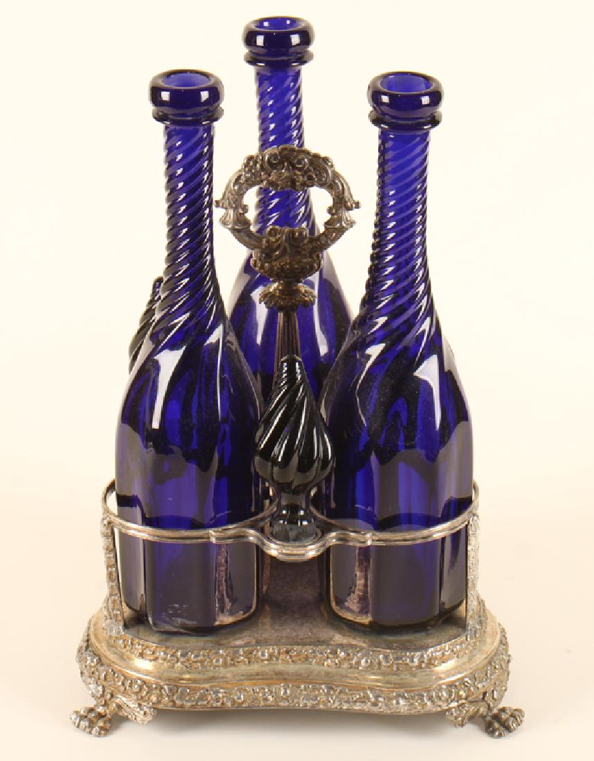 TRIO OF BLUE GLASS BOTTLES ON SILVER BASE (1 of 3)