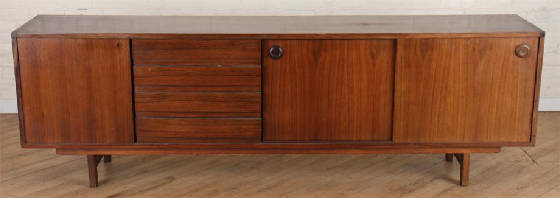 DANISH MODERN ROSEWOOD SIDEBOARD CIRCA 1960: A Danish modern rosewood sideboard having two sliding doors, four drawers and a door circa 1960. Ht: 29.75" Wd: 94.25" Dpth: 17.75"