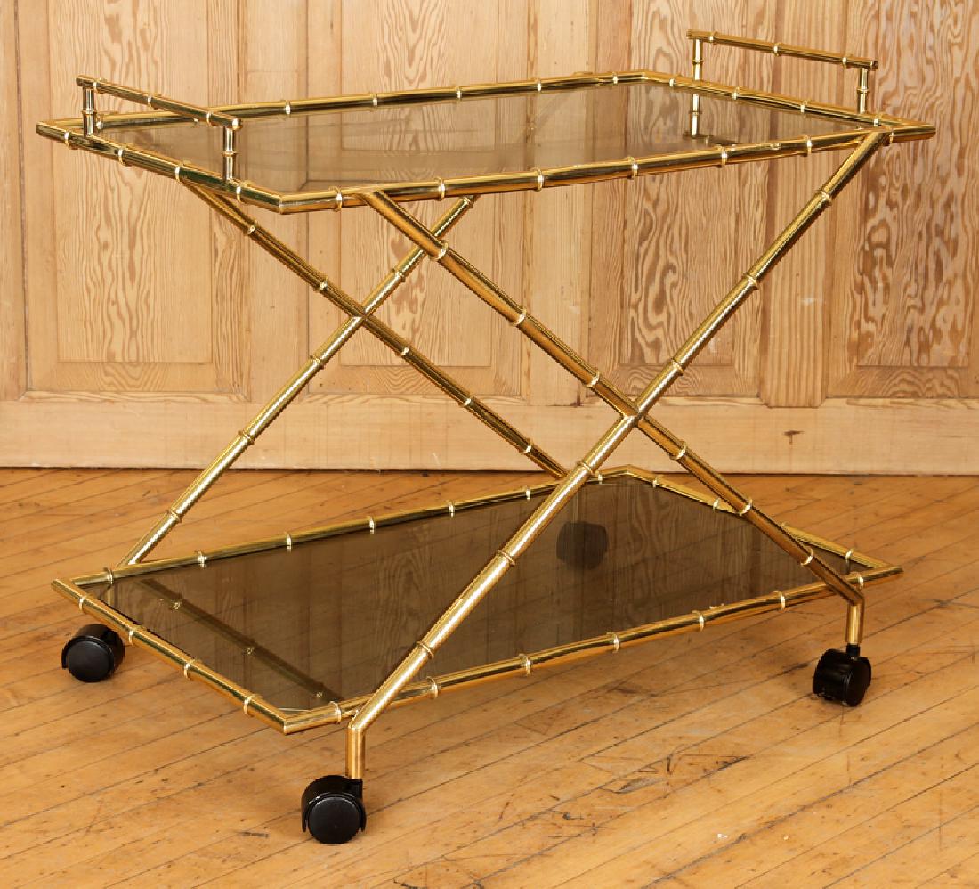 SEXY BRONZE SMOKED GLASS BAR CART C.1970: A sexy bronze and smoked glass bar cart circa 1970. Having x-form and bamboo motif. Ht: 27" Wd: 31.5" Dpth: 19"