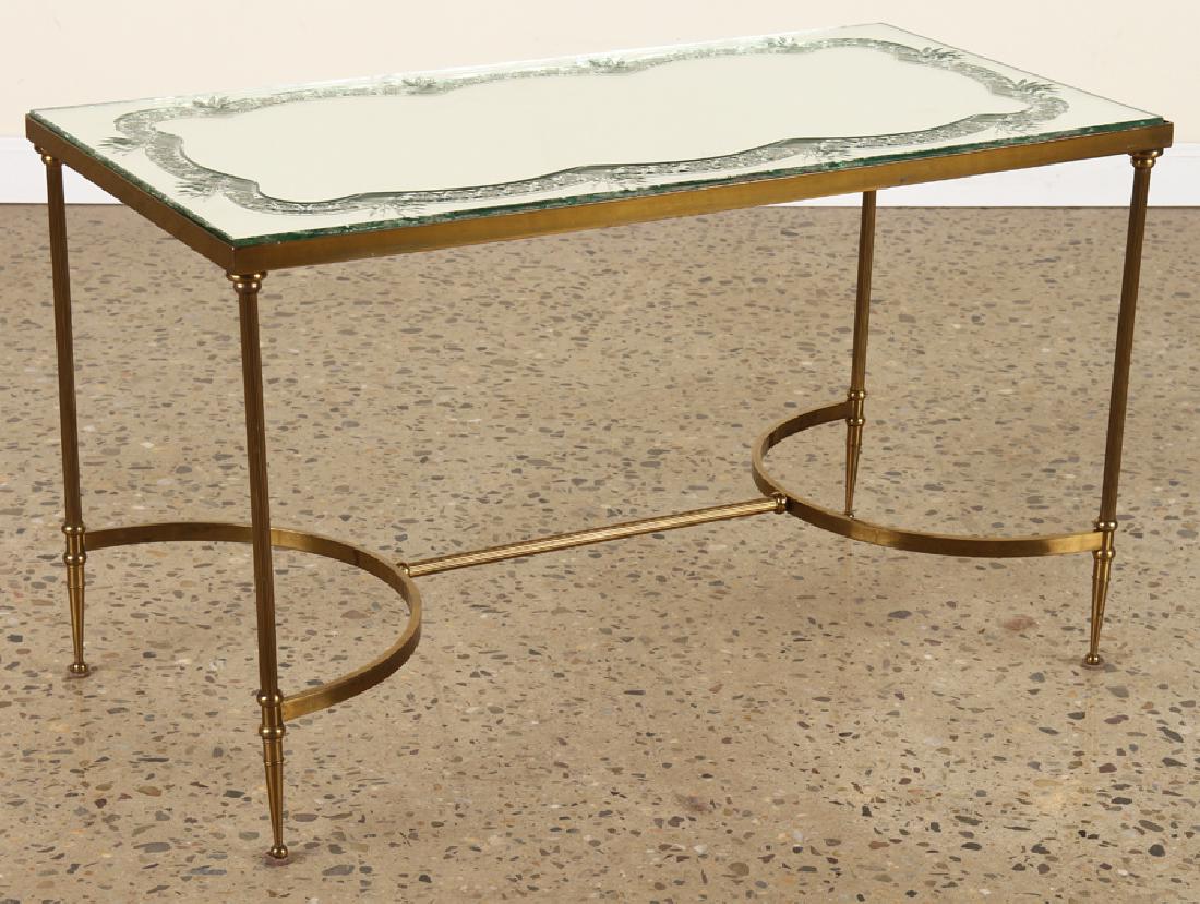 BRONZE COFFEE TABLE WITH ETCHED GLASS TOP C.1940: A bronze coffee table having curved h-form stretcher having etched mirror top circa 1940. Ht: 18.5" Wd: 32" Dpth: 16"