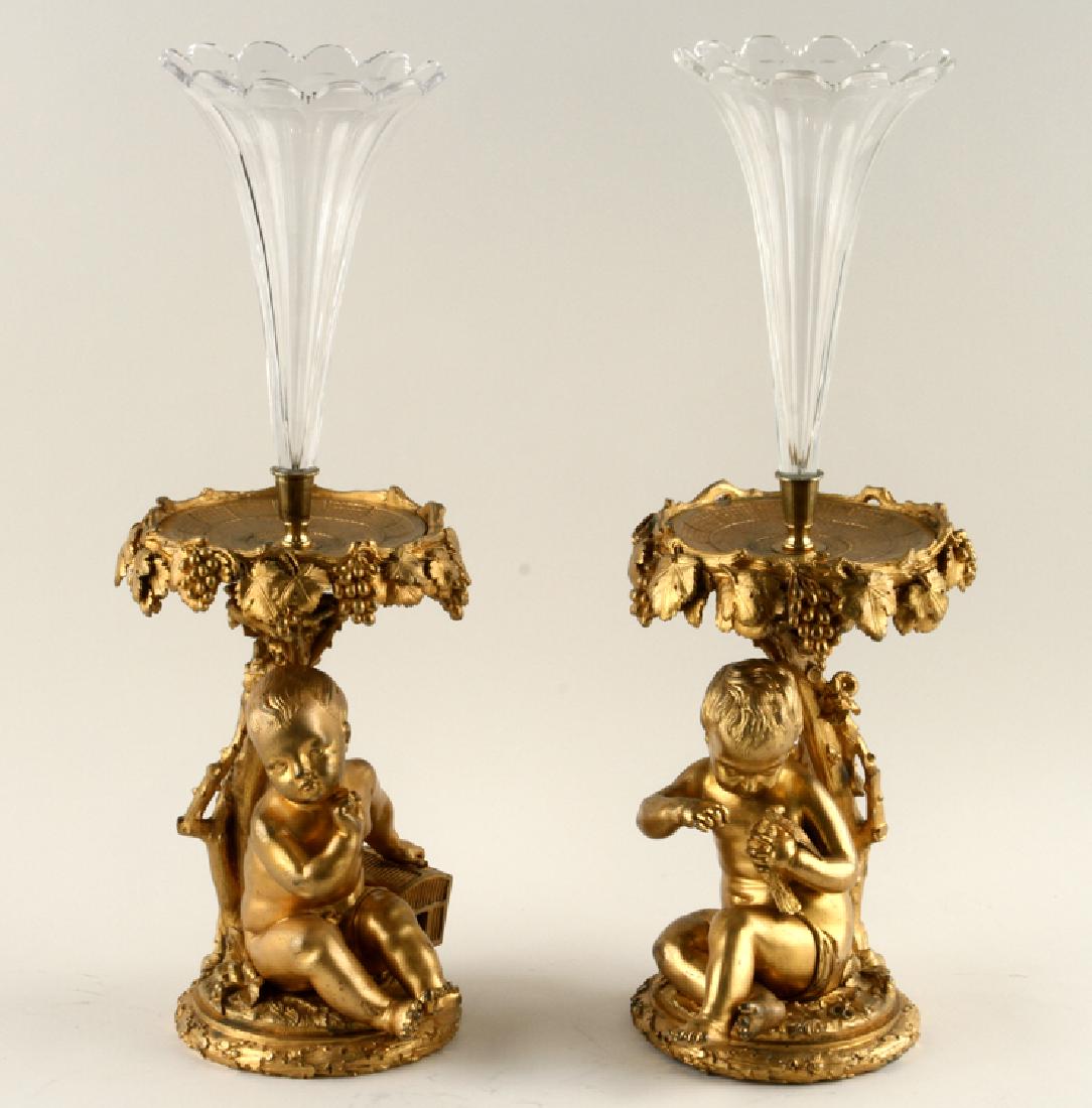 PAIR BRONZE AND CUT CRYSTAL EPERGNES ON BASES: A pair of bronze and cut crystal epergnes raised on bronze figures resting on naturalistic round bases. Ht: 21" Dia: 8"