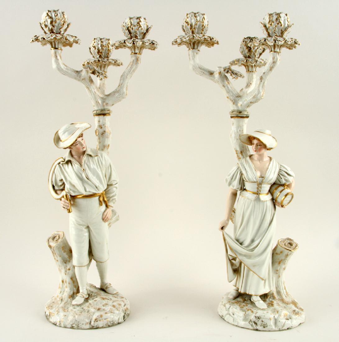 PAIR JAMES HADLEY ROYAL WORCESTER CANDELABRA: James Hadley (English, 1837-1903) A pair of Royal Worcester hand painted porcelain figural candelabra, both marked. Ht: 21" Dia: 8.5"