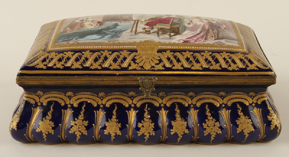 LATE 19TH C FRENCH SEVRES PORCELAIN BRONZE CASKET: A late nineteenth century French Sevres cobalt porcelain and gilt bronze casket. Having hand painted domed cover with an artist studio scene. Marked to base. Ht: 5.25" Wd: 13.5" Dpth: 8.75"