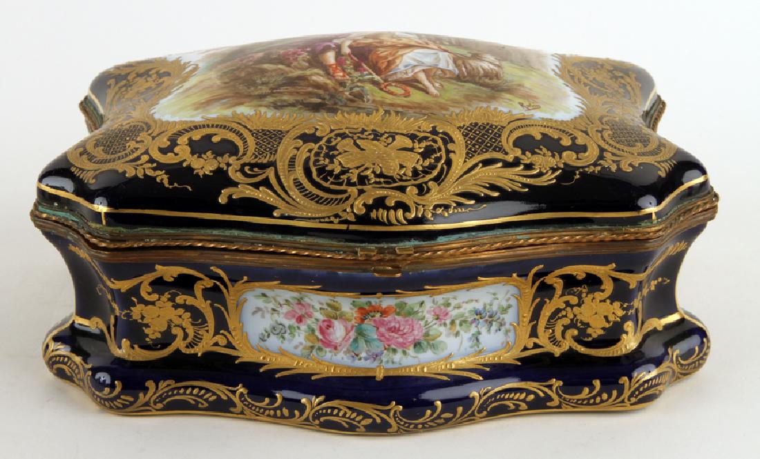 LATE 19TH C FRENCH COBALT PORCELAIN BRONZE CASKET: A late nineteenth century French cobalt porcelain and bronze casket. The casket having hand painted courting scene to cover, signed Robin. Interior having hand painted botanicals. Marked to base. Ht: 