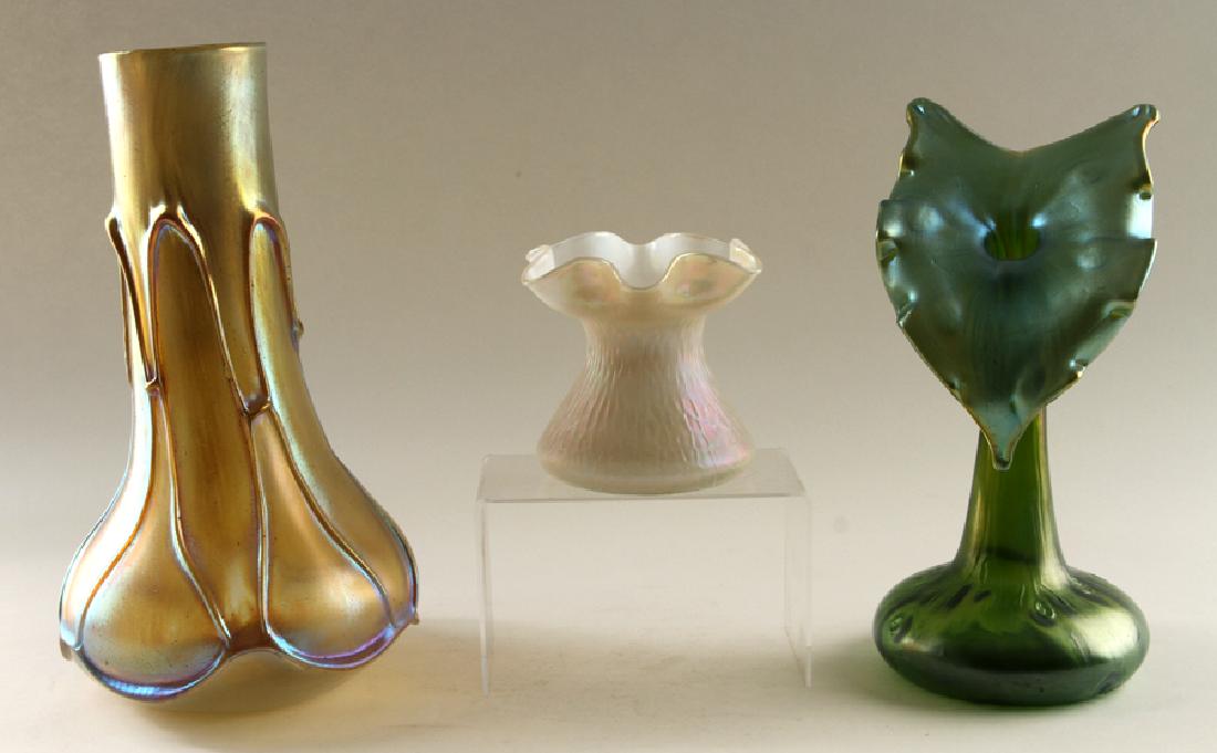 THREE MARKED LOETZ IRIDESCENT ART GLASS VASES: A lot of three marked Loetz iridescent art glass vases. Jack in the Pulpit vase: 12.5" Largest vase: 14.25" Smallest vase: 5.25" All three marked Loetz Austria.